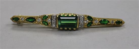 A modern 18ct gold, green tourmaline and diamond set bar brooch, 61mm.